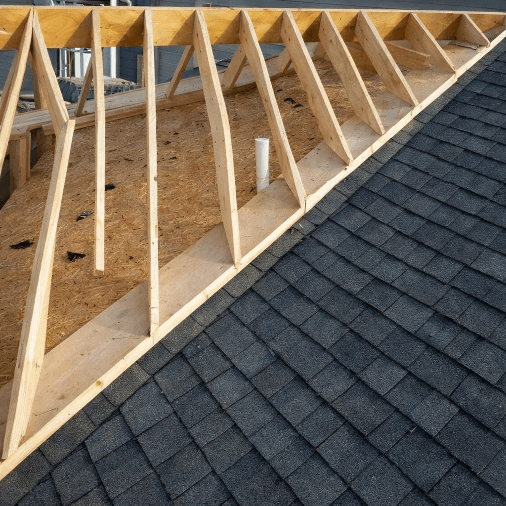 Roofing crew working on a residential roof during a solar detach-and-reset project